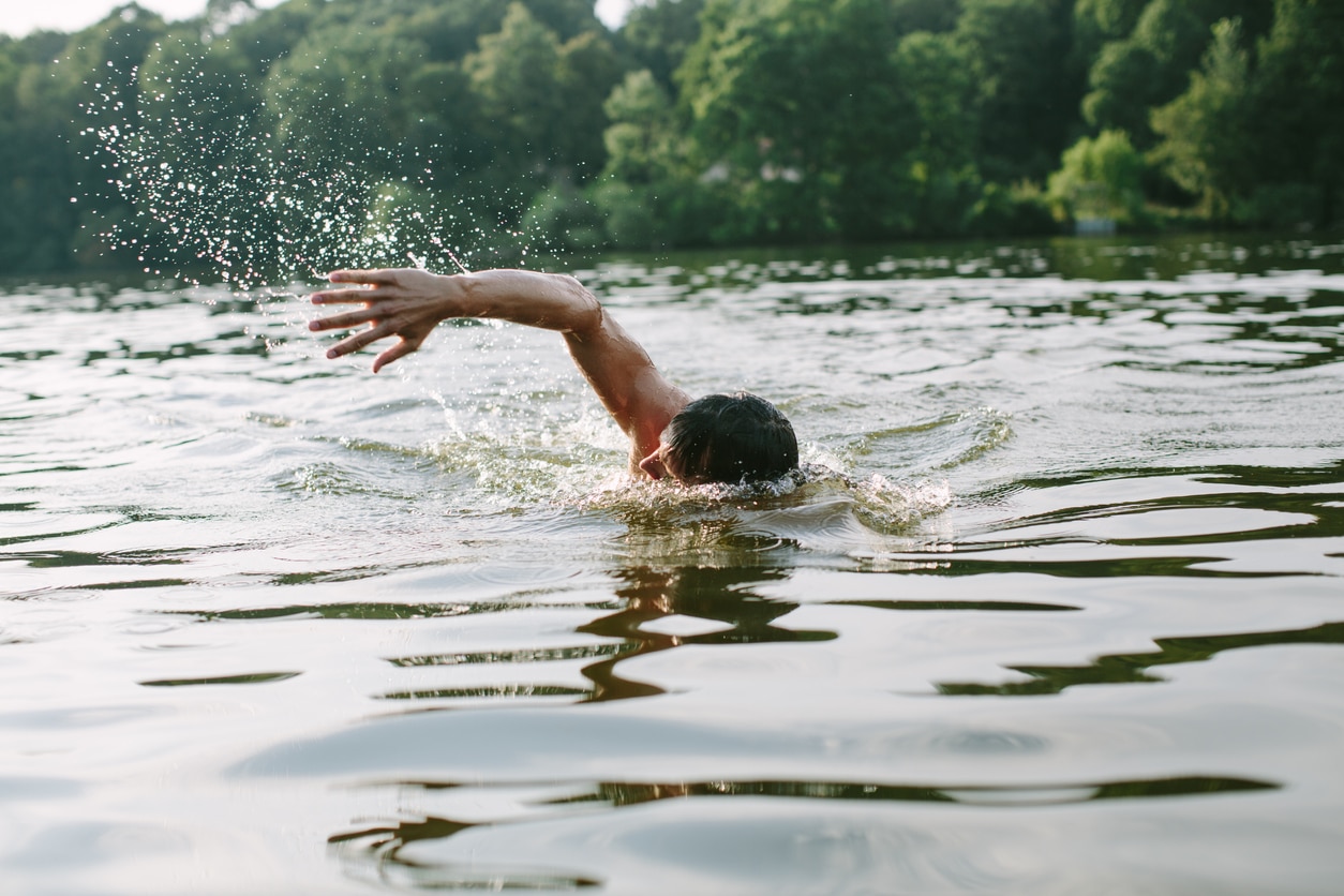 Man swimming at a lake.