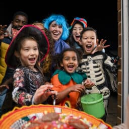 Kids and adults in costume trick or treating